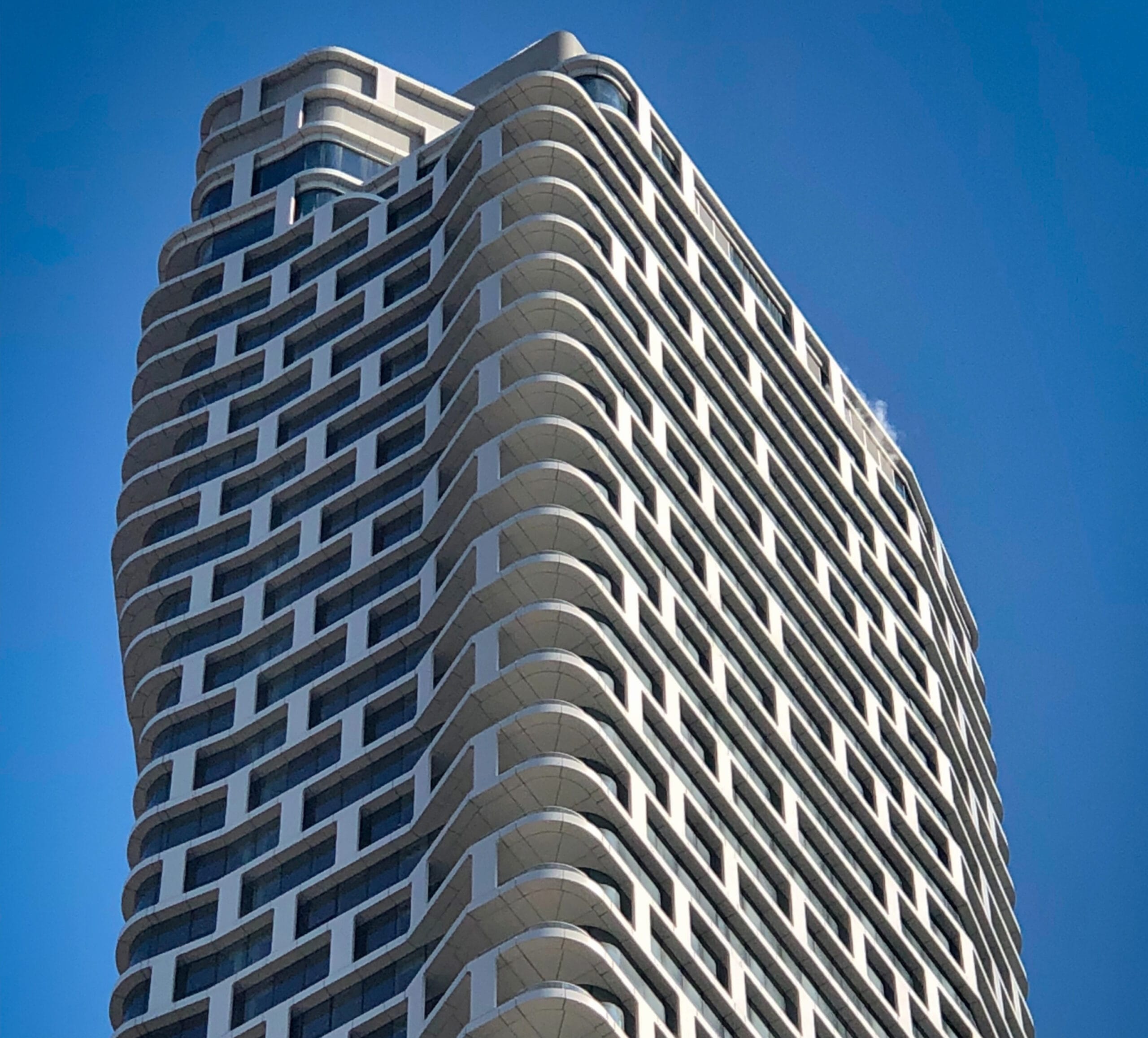 Image of 242-West-53rd Street in New York. Shows undulating surface of the exterior. CentraRuddy Architecture, custom unitized rainscreen system by Riverside Group.