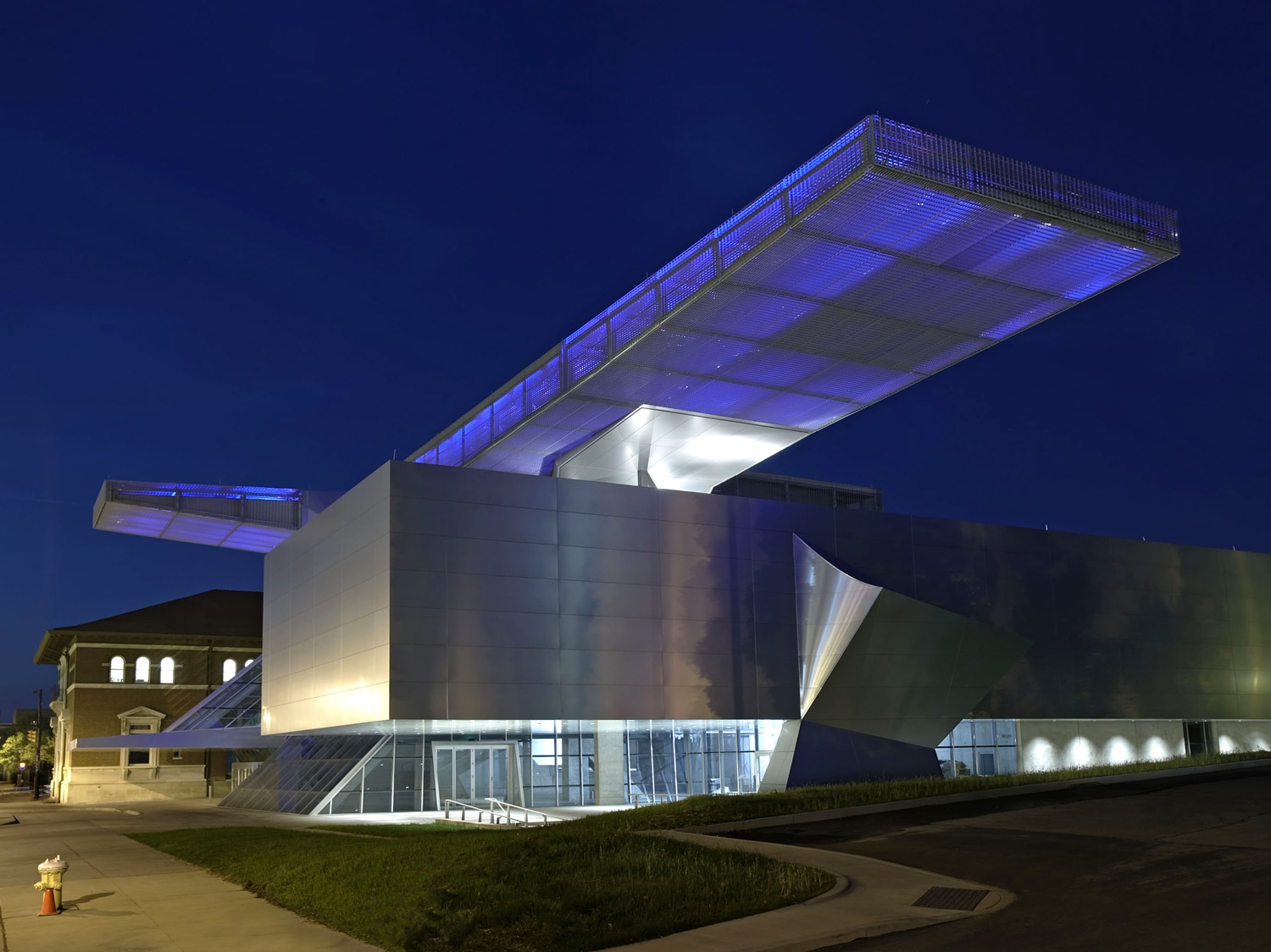 Exterior night view of the sculpture at Akron Art Museum in Akron, Ohio. Coop-Himmelblau Architects, rainscreen cladding system by Riverside Group.