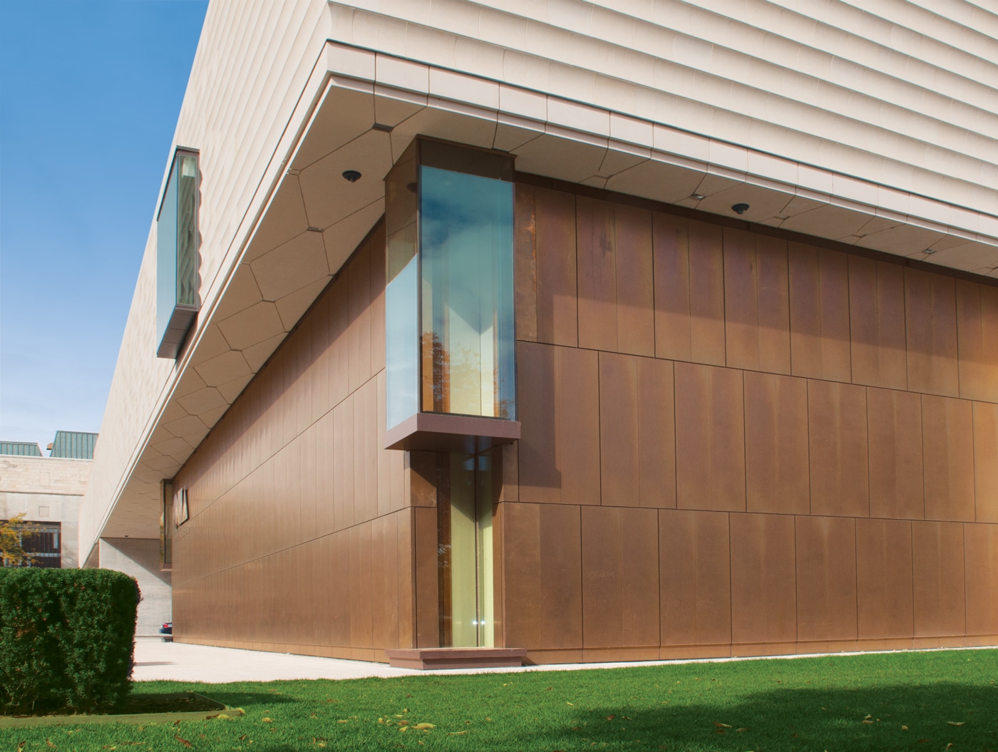 Image of corner window and two walls at Chazen Museum of Art in Madison, Wisconsin. Patined bronze wall surface. Rainscreen cladding system by Riverside Group.