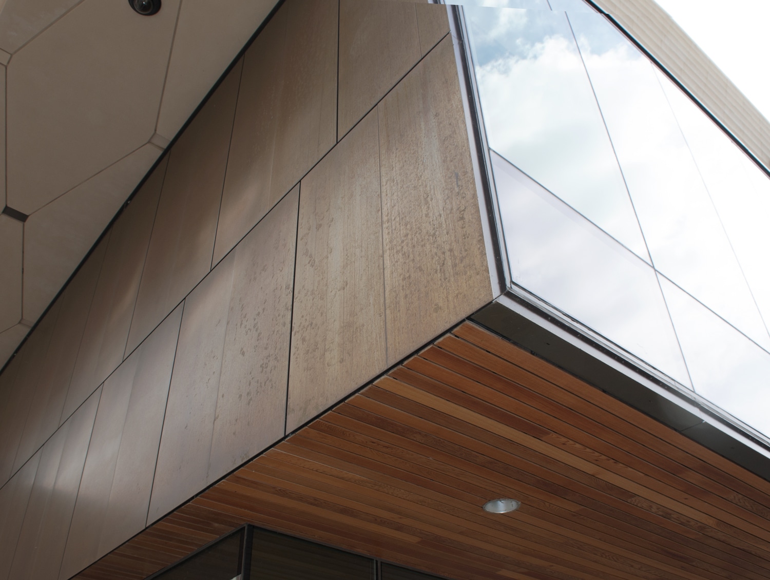 Detail image of exterior facade at Chazen Museum of Art shows patined bronze surface. Architectural system by Riverside Group.
