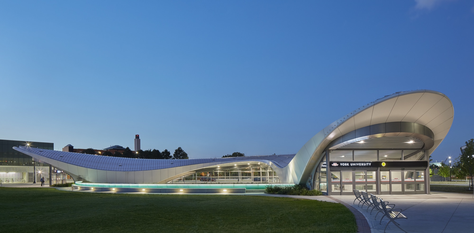 Evening photo of TTC York University Station in Toronto, Ontario shows curvature of the building.
